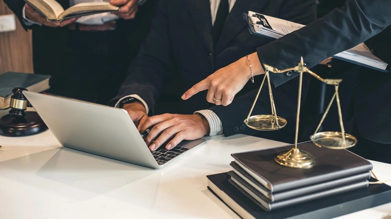 Legal team working on laptop | Robinson Investigations & Conflict Resolution